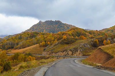 Road amidst mountains against sky