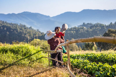 Man standing on field against mountain