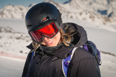 Skier smiling happy cheerful satisfied woman in warm windbreaker jacket ski goggles mask glasses