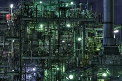 Low angle view of illuminated industry at night