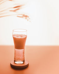 Select focus composition with glass filled with light beer with foam on sunset summer background 