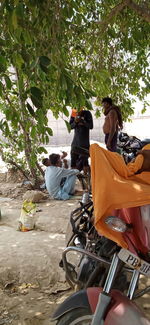 Rear view of people riding motorcycle