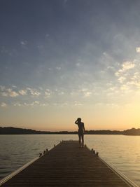 Silhouette of man standing on pier