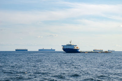 Ship sailing on sea against sky