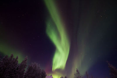 Low angle view of illuminated mountain against sky at night