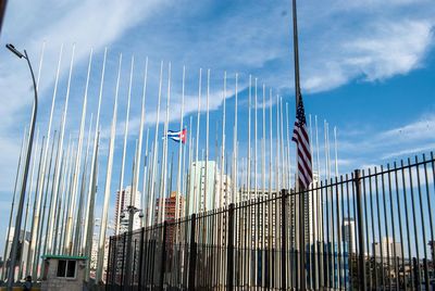 Low angle view of flag in city against sky