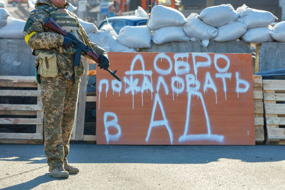 Welcome to hell inscription on a wooden shield at the kyiv checkpoint .