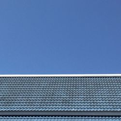 Low angle view of roof against clear blue sky