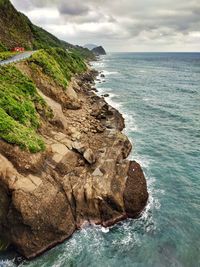 Scenic view of rocks in sea against sky