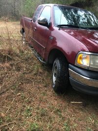 Abandoned car on field