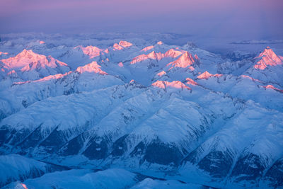 Scenic view of snow covered mountains against sky