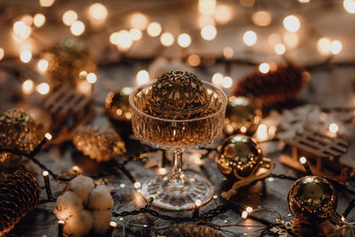 Close-up of illuminated candles on table