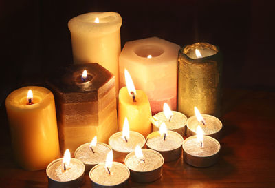 Close-up of illuminated candles on table