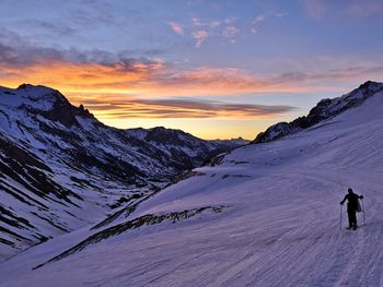 Scenic view of snowcapped mountains against sky during sunrise