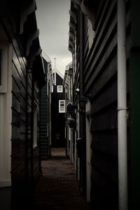 Empty alley amidst buildings in city