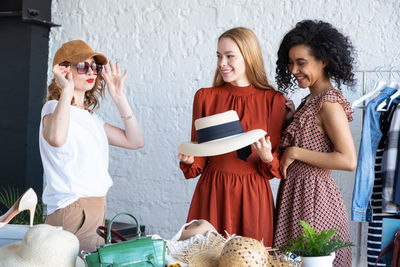 Smiling female friends at flea market