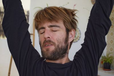 Close-up of bearded young man with eyes closed