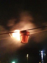 Low angle view of illuminated street light against sky at night