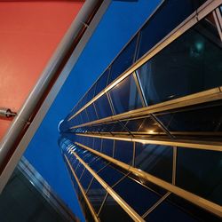 Low angle view of illuminated bridge against blue sky