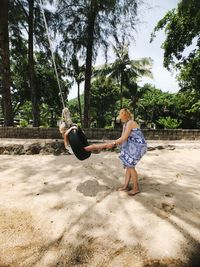 Mother playing with daughter at beach