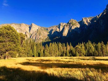 Scenic view of mountains against clear blue sky