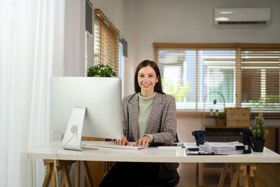 Young woman using laptop at office