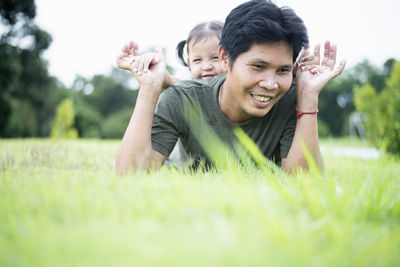 Portrait of young woman sitting on grassy field