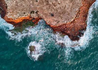 High angle view of rock formation in sea