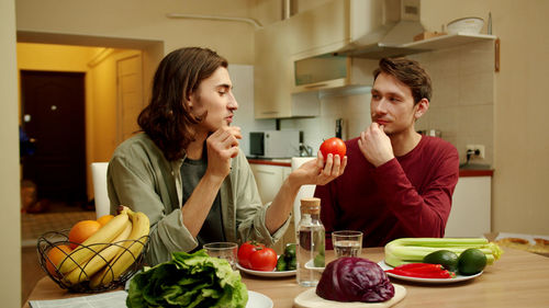 Young couple preparing food in kitchen at home