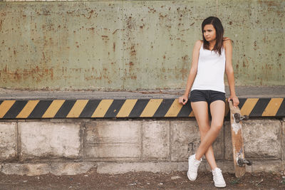 Woman leaning on wall