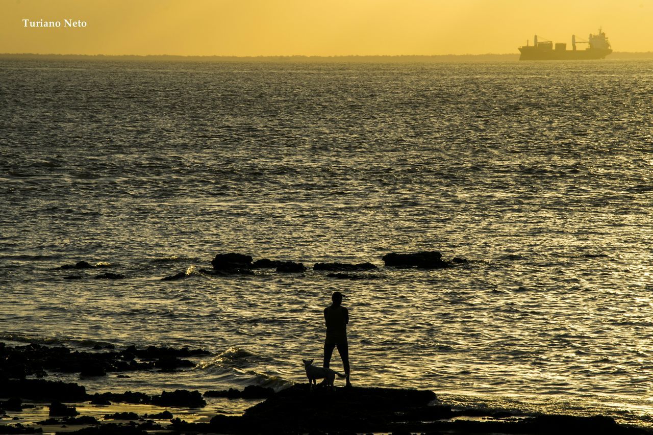 sea, water, sunset, silhouette, men, leisure activity, lifestyles, horizon over water, rippled, scenics, tranquil scene, standing, beauty in nature, nature, tranquility, person, orange color, fishing