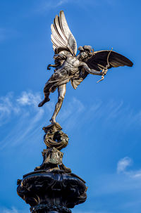 Low  view of eros statue against sky