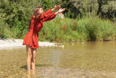 Woman standing by lake