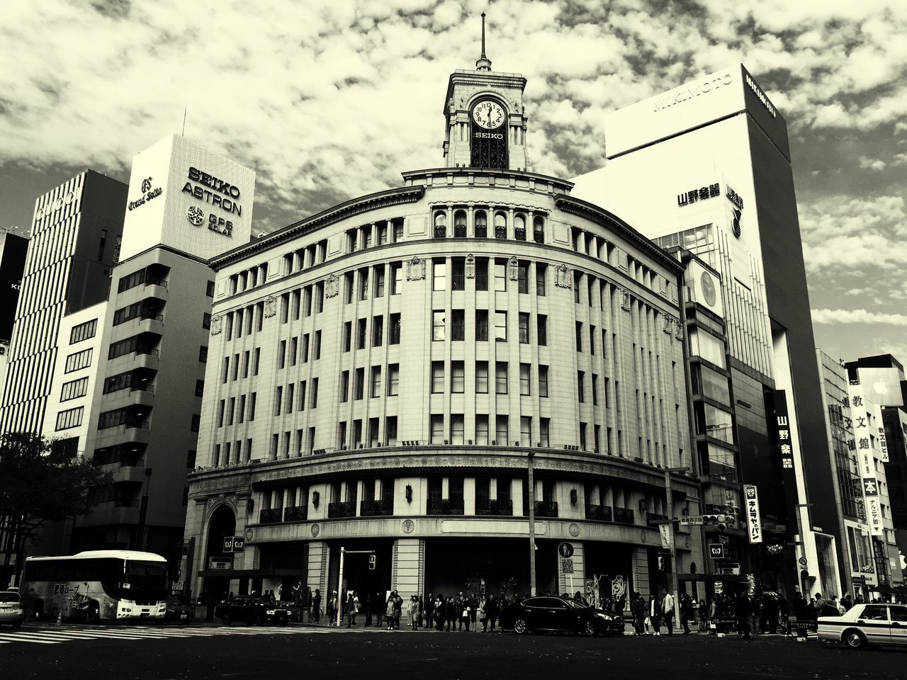 LOW ANGLE VIEW OF OFFICE BUILDING AGAINST CLOUDY SKY