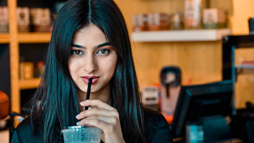 Young woman drinking glass