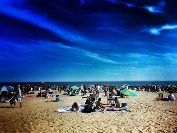 Scenic view of beach against blue sky