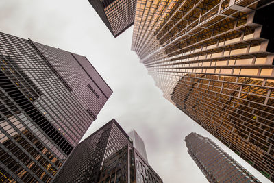 Low angle view of tall buildings against sky