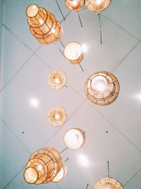 Low angle view of illuminated pendant light hanging from ceiling