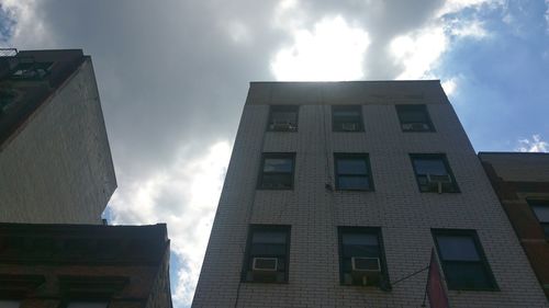 Low angle view of building against cloudy sky