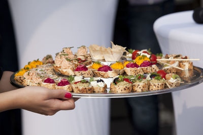 Close-up of woman holding food in tray