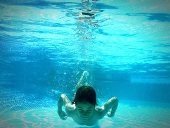 Boy swimming in pool