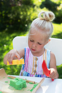 Close-up of cute girl holding table