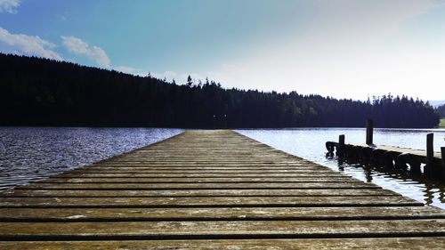 Pier over lake against sky