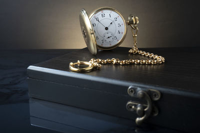 Close-up of clock on table at home