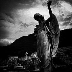 Silhouette of woman against cloudy sky