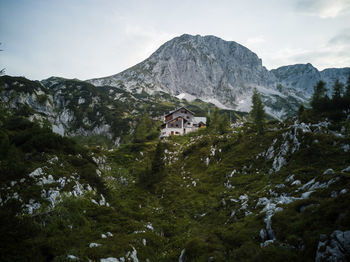 Scenic view of mountains and buildings against sky