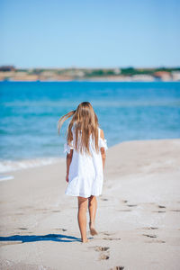 Full length of woman standing at beach