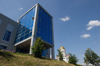 Low angle view of modern building against clear blue sky