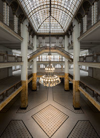 Illuminated chandelier hanging from ceiling