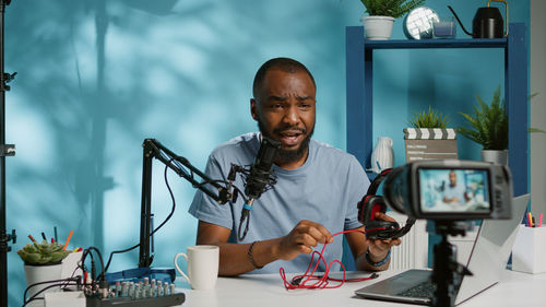 Young man with headphones sitting at desk